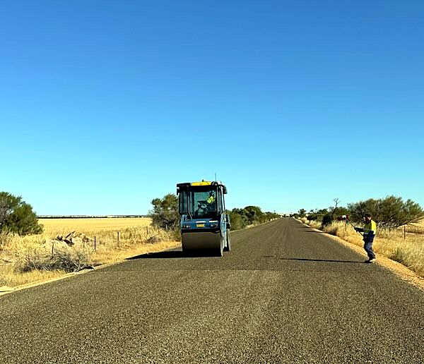 Supervisor inspecting the seal as the roller follows